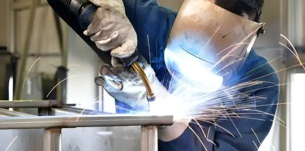 Worker Welding Stainless Steel Metal Products
